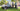 Group of men with EGO lawn mowers in a park setting